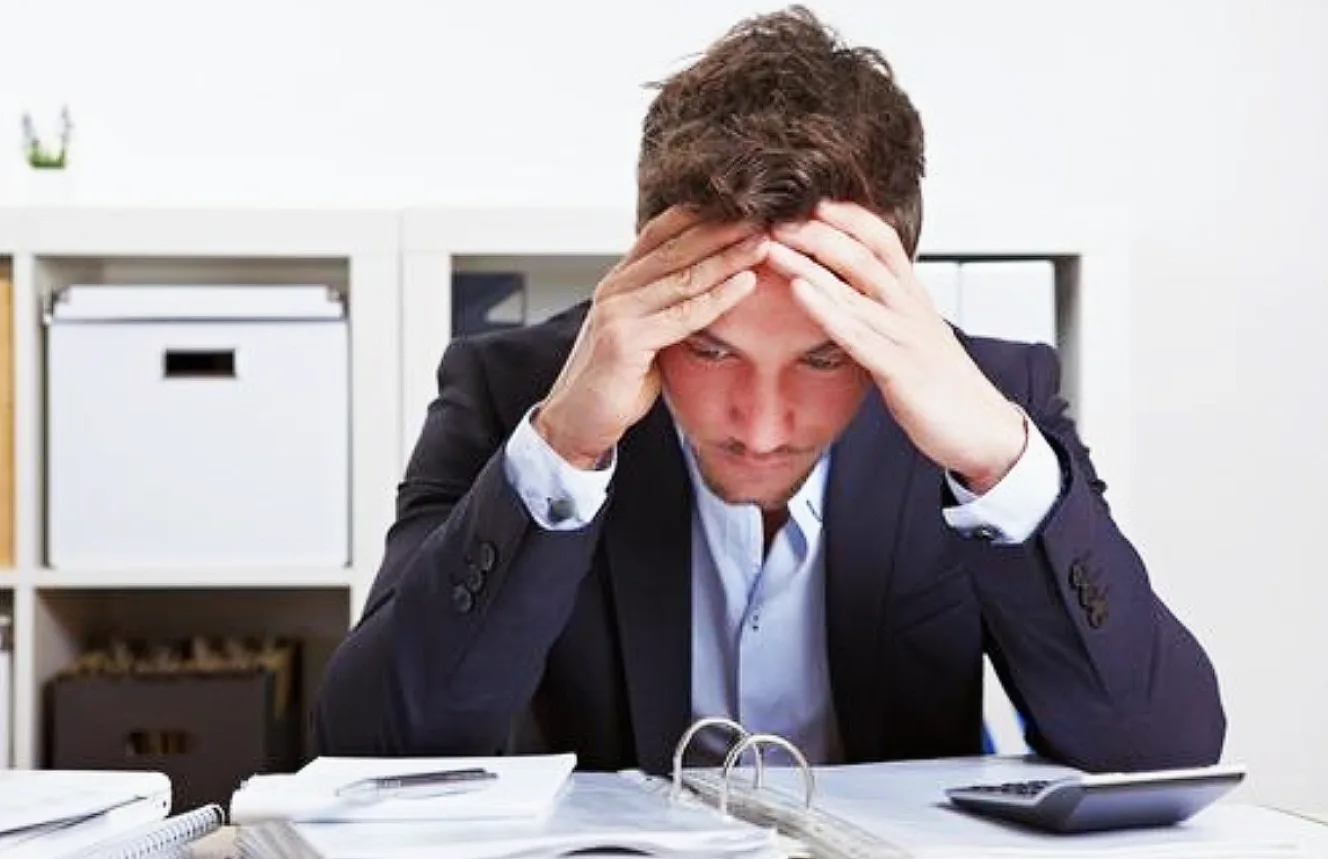 Man with hands on his forehead